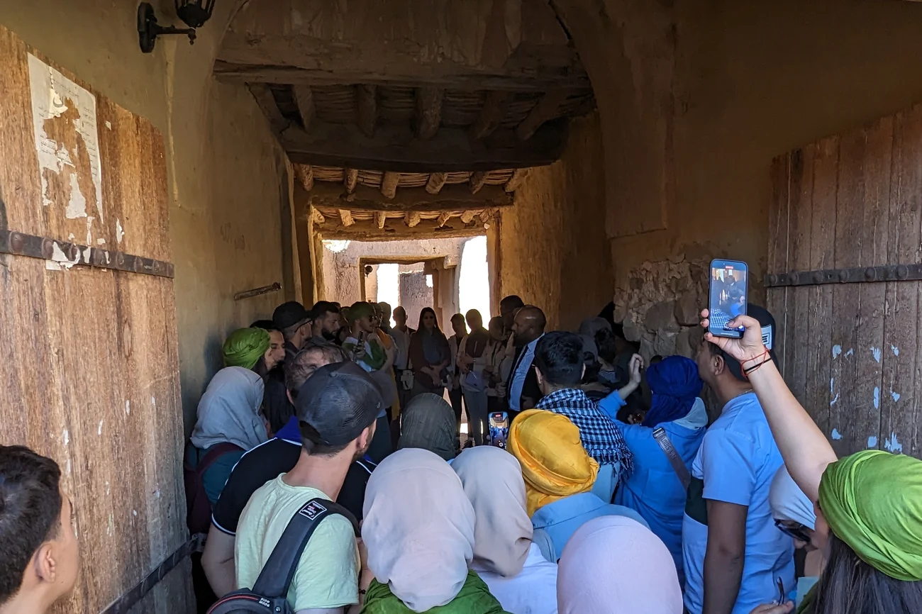 Travellers climbing the steps to the old ksar at El Menia