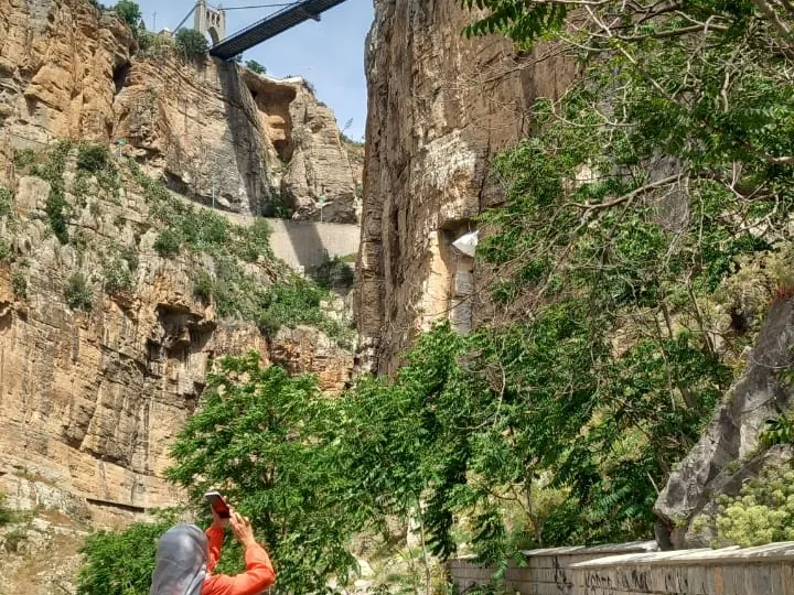 A traveller photographing the Rhumel gorge at Constantine