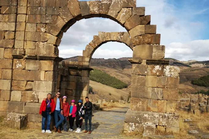 A Tourago group in front of the Arch of Caracalla at Djemila