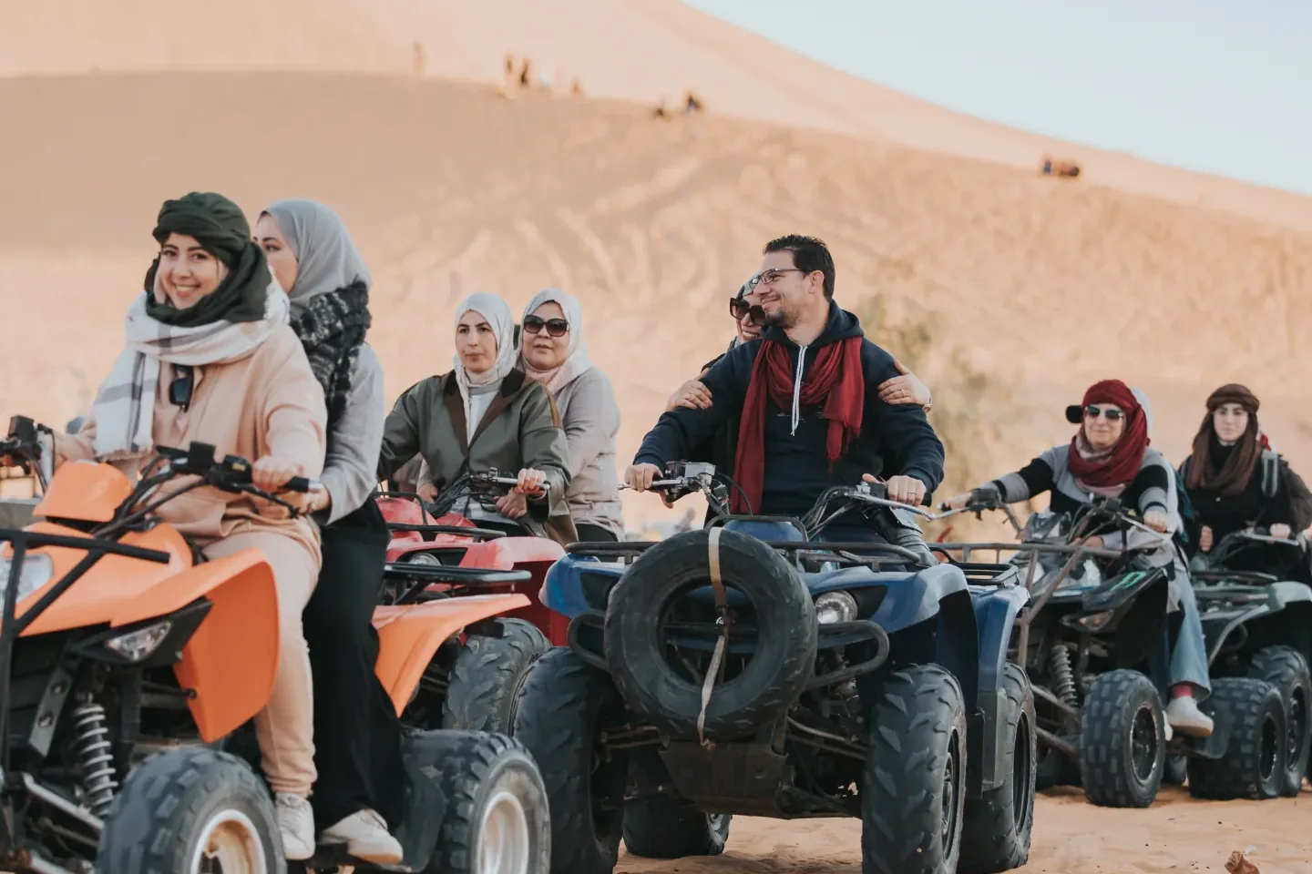 Travellers on quad bikes at the foot of the dunes at Taghit