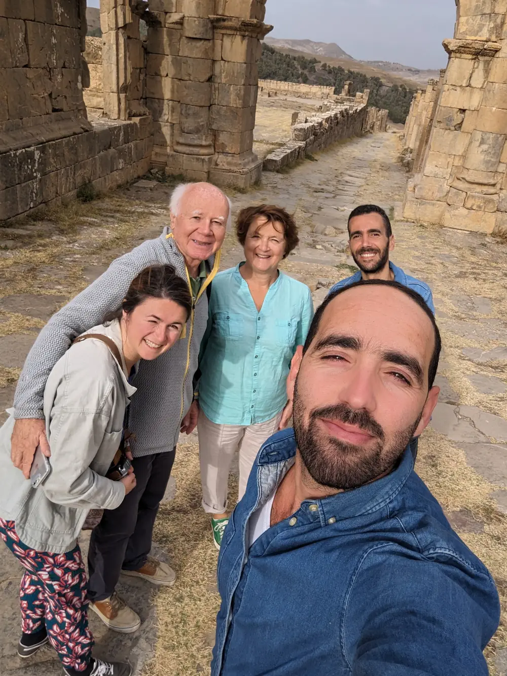 Travellers together under the Arch of Caracalla at Djemila
