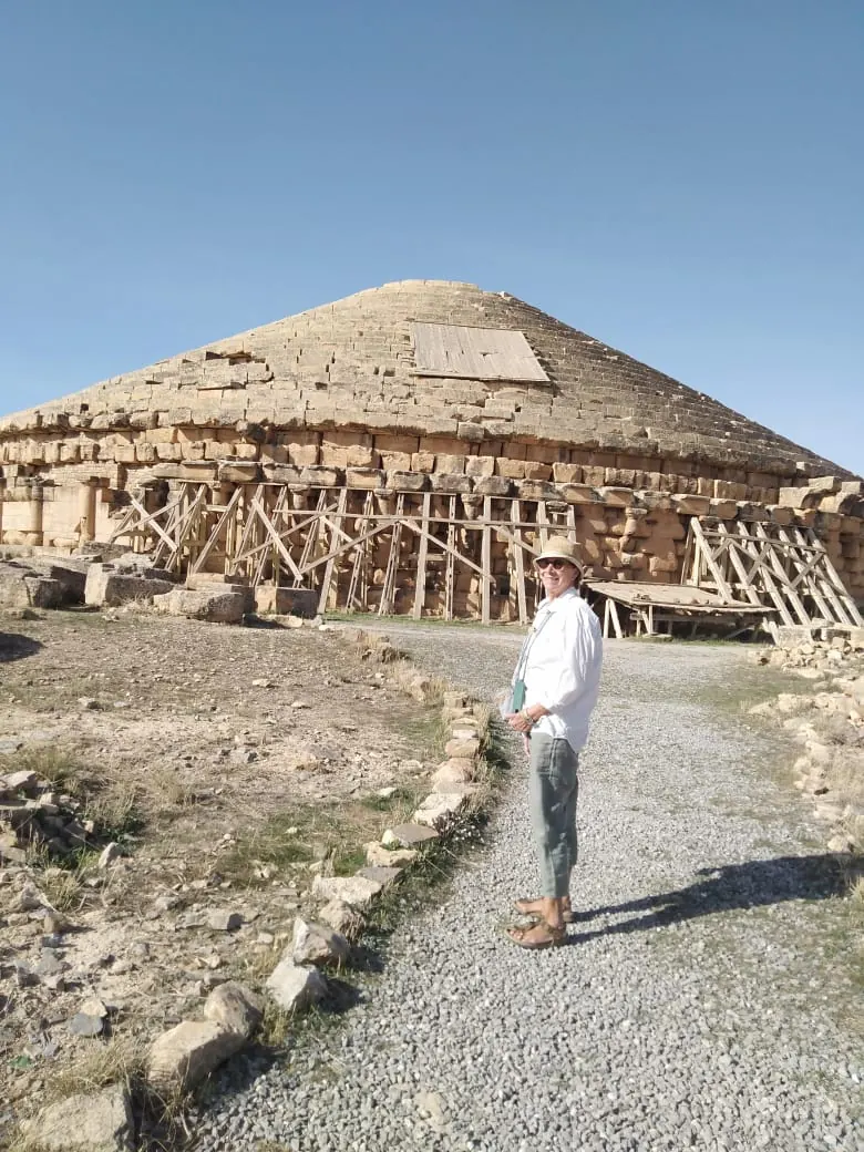 A traveller on the path up to the Imedghassen mausoleum, under restoration