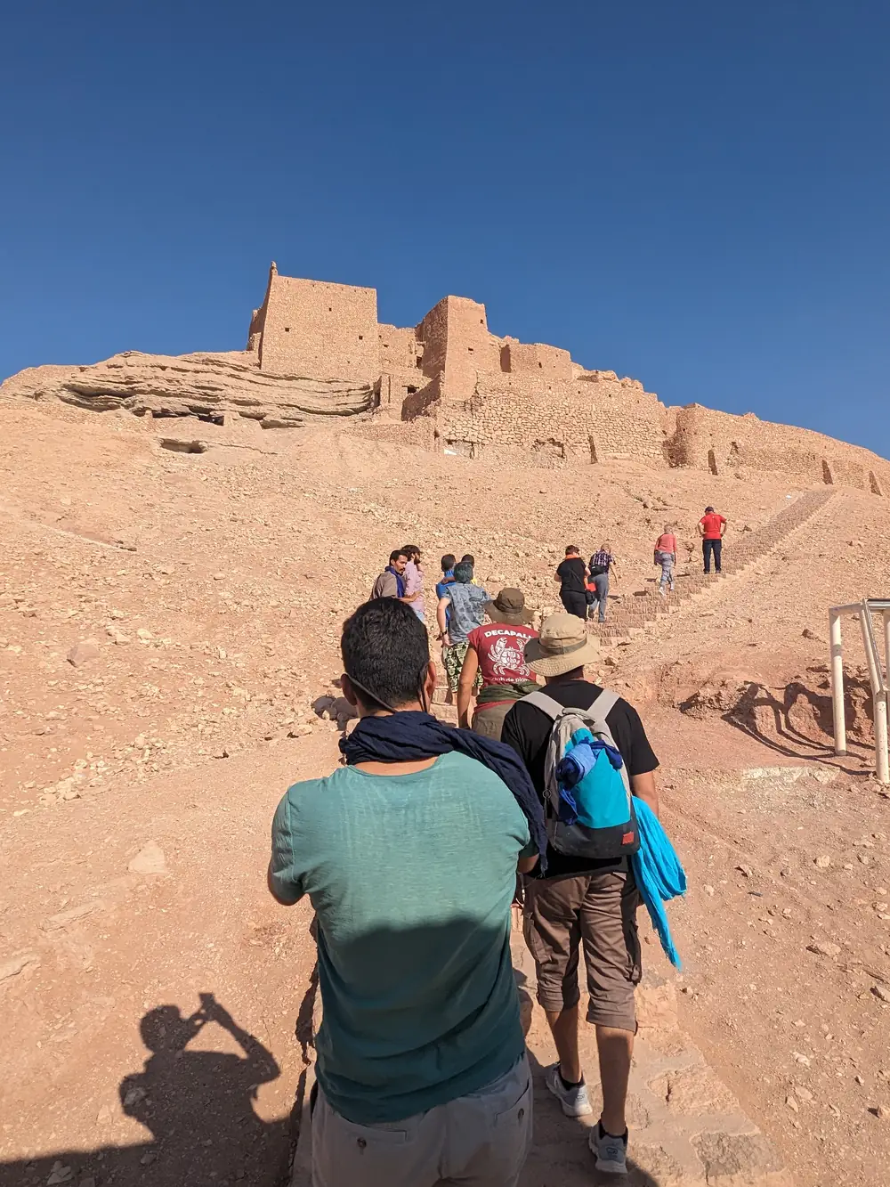 Travellers climbing the path to the old ksar at El Menia